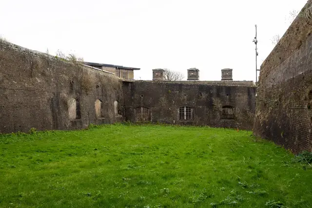 Revetted defensive face and graded embankment